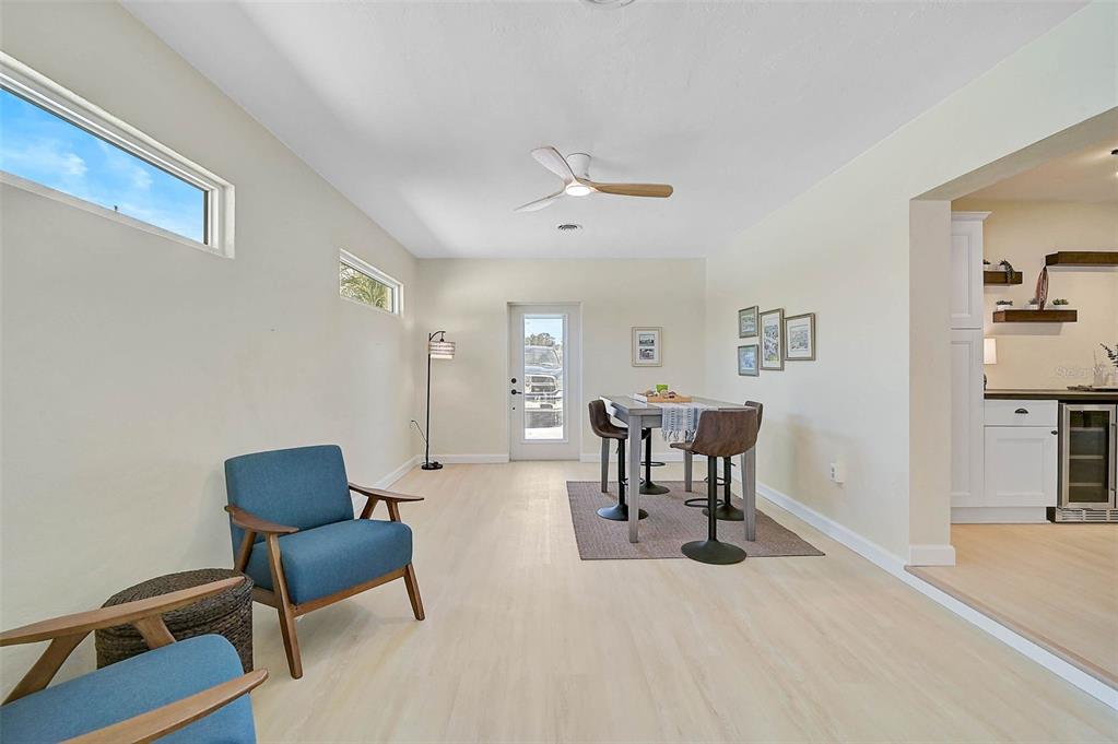 1099 Nokomis Avenue South Venice, FL 34285 - Photo 7 of 68 a living room with furniture and a chair