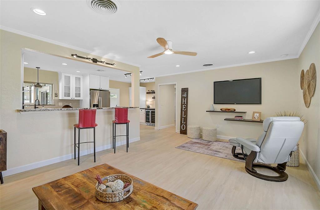 1099 Nokomis Avenue South Venice, FL 34285 - Photo 8 of 68 a living room with furniture and a flat screen tv