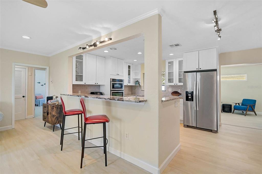 1099 Nokomis Avenue South Venice, FL 34285 - Photo 9 of 68 a kitchen with stainless steel appliances kitchen island granite countertop a refrigerator and a stove