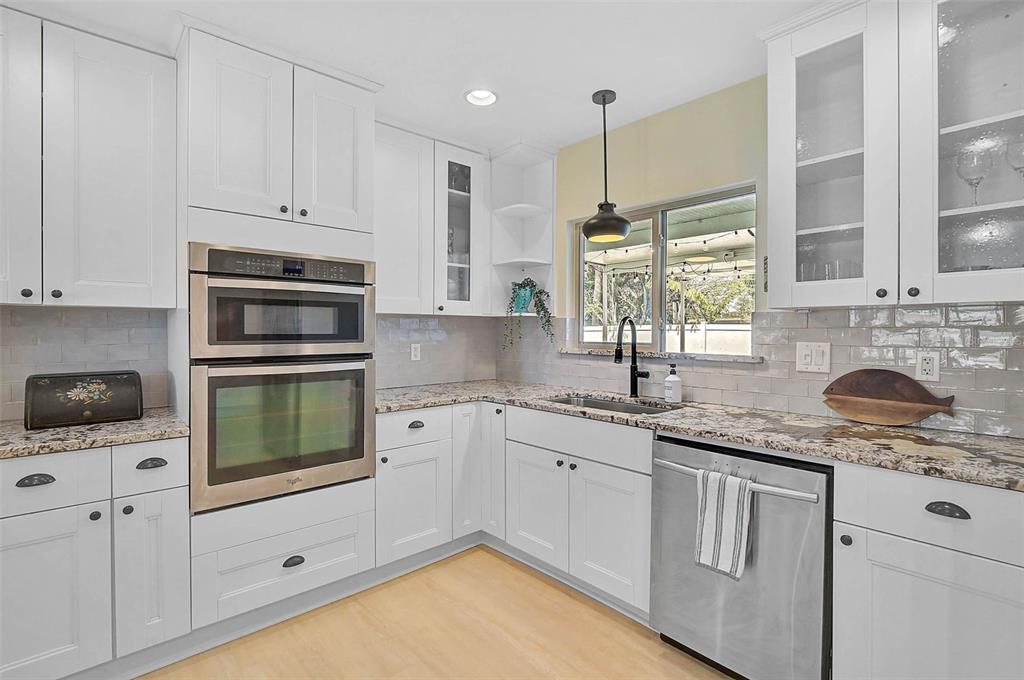 1099 Nokomis Avenue South Venice, FL 34285 - Photo 10 of 68 a kitchen with granite countertop white cabinets and white appliances