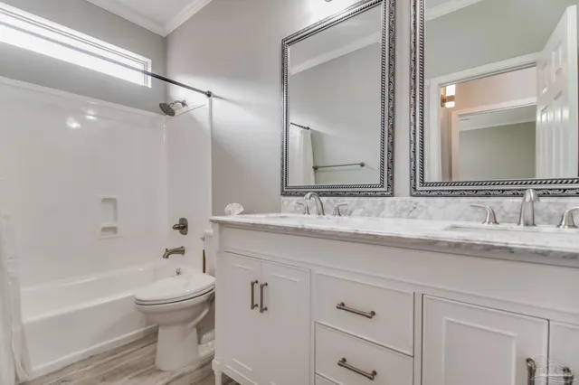 a bathroom with a granite countertop sink a toilet and a bathtub