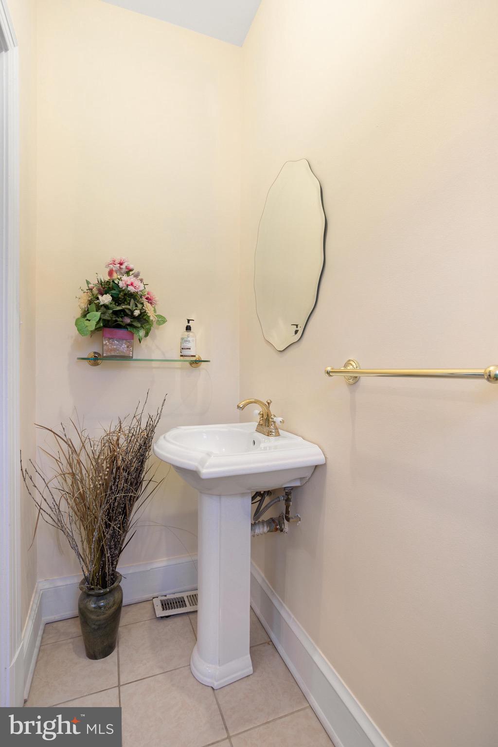 4604 Nottingham Drive Chevy Chase, MD 20815 - Photo 15 of 35 a table with a sink and a mirror