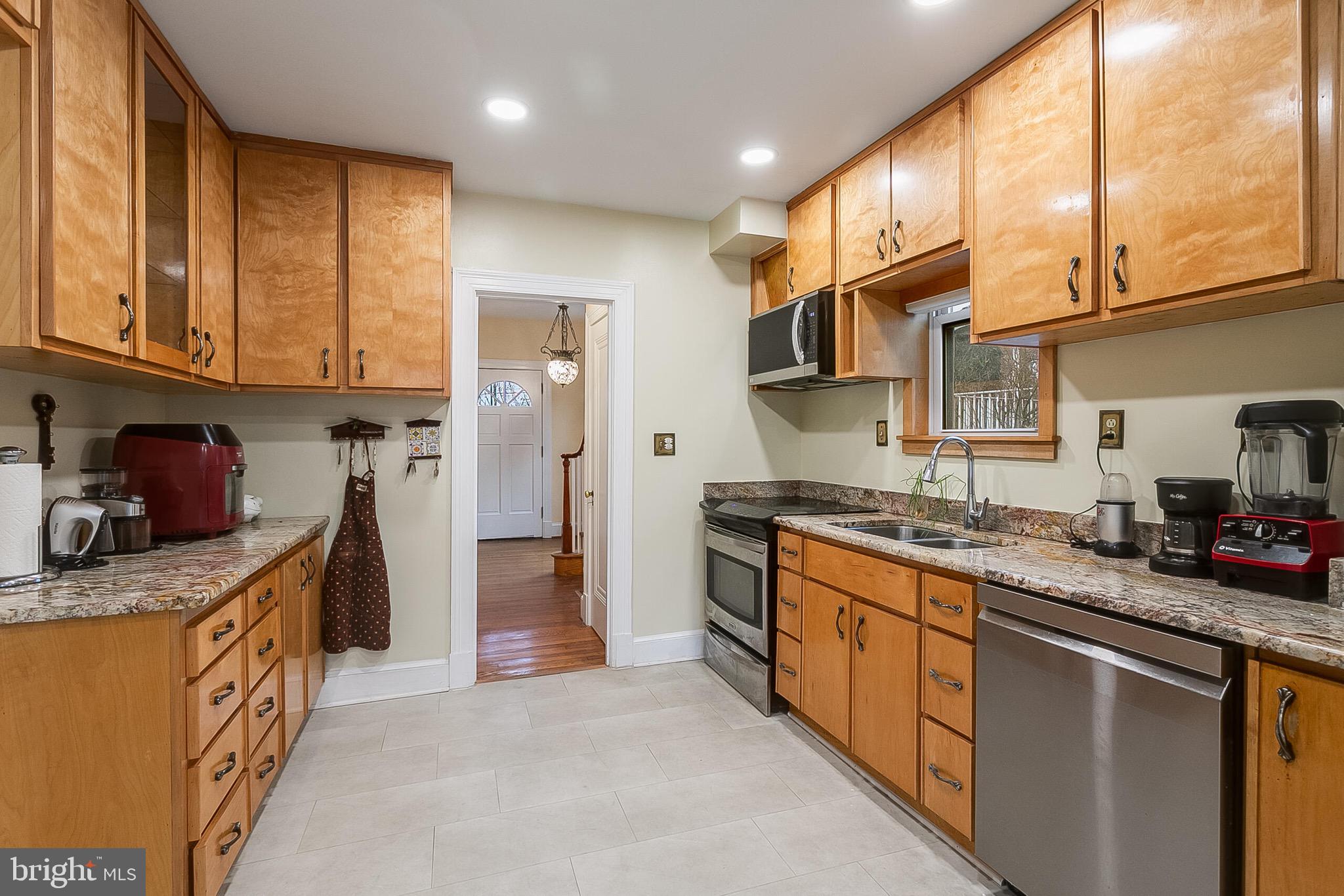 4604 Nottingham Drive Chevy Chase, MD 20815 - Photo 7 of 35 a kitchen with stainless steel appliances granite countertop a stove a sink and a refrigerator