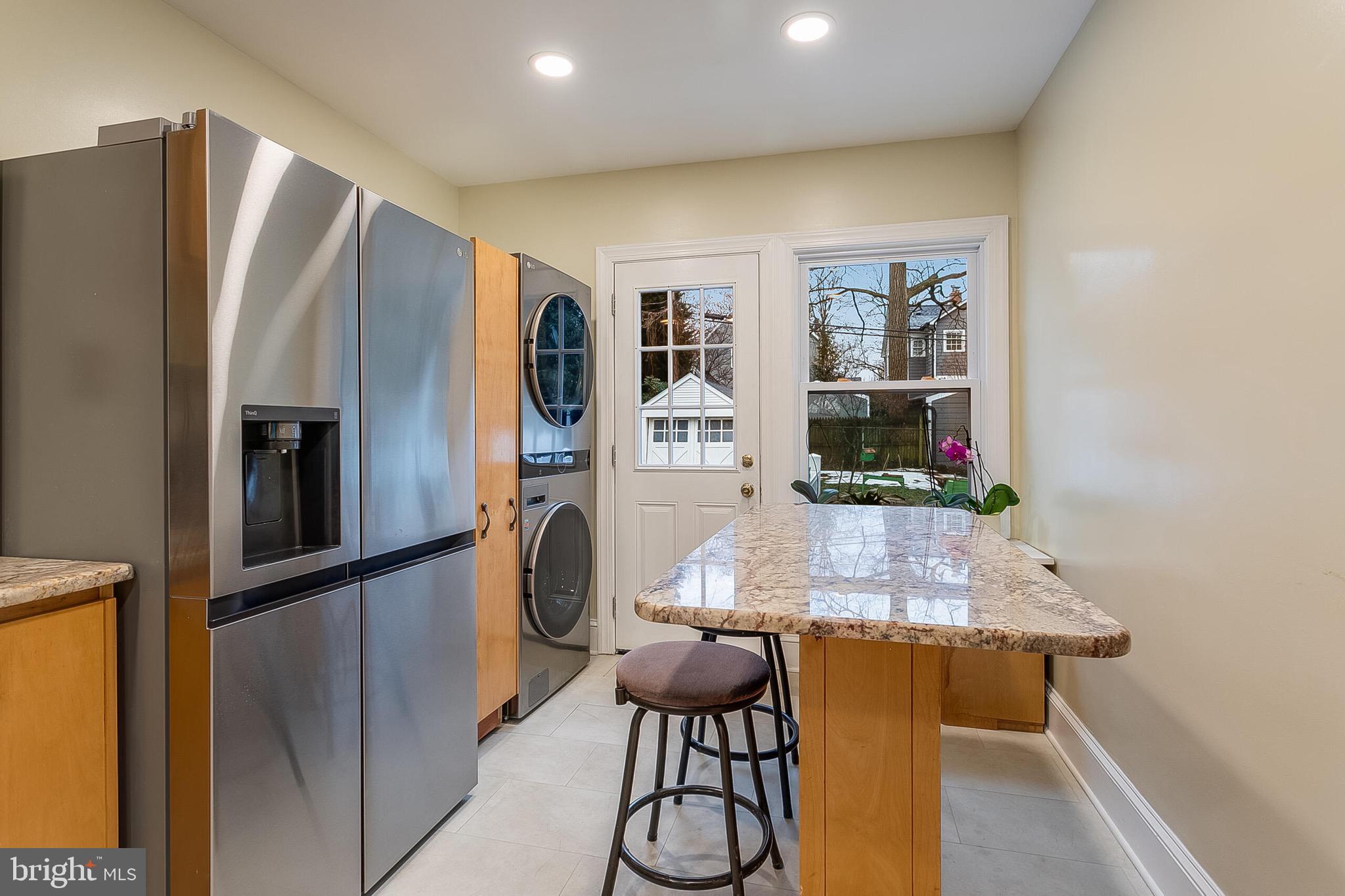 4604 Nottingham Drive Chevy Chase, MD 20815 - Photo 9 of 35 a kitchen with stainless steel appliances granite countertop a refrigerator and a stove top oven
