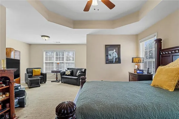 a bedroom with furniture and a large window