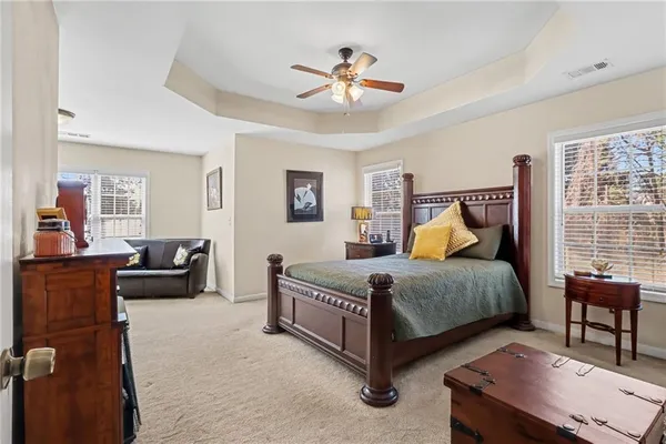 a bedroom with a bed and a chandelier