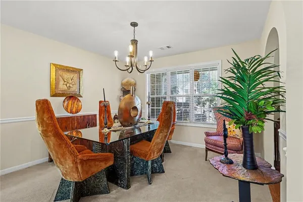 a dining room with furniture and wooden floor