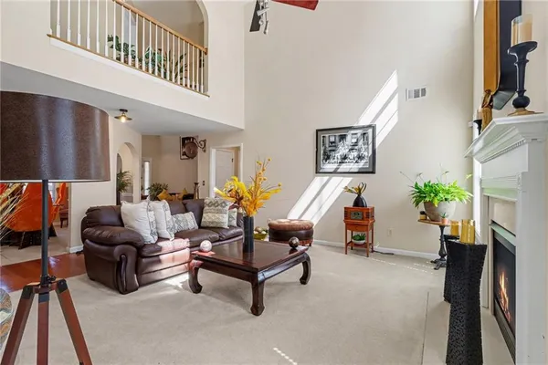 a living room with furniture and a potted plant