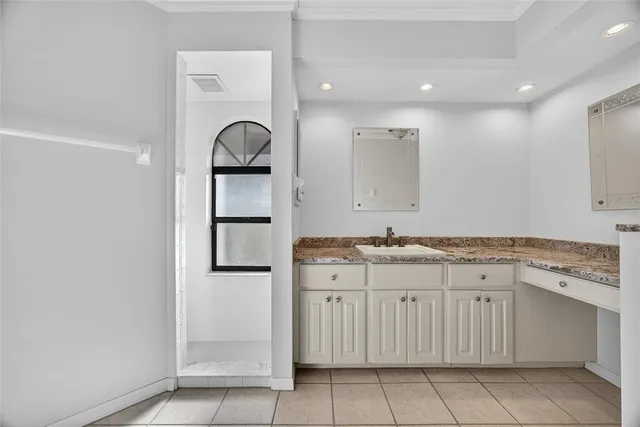a bathroom with a granite countertop sink a mirror and a vanity