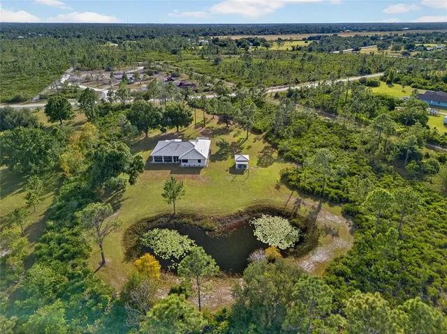 an aerial view of a house with a yard and garden