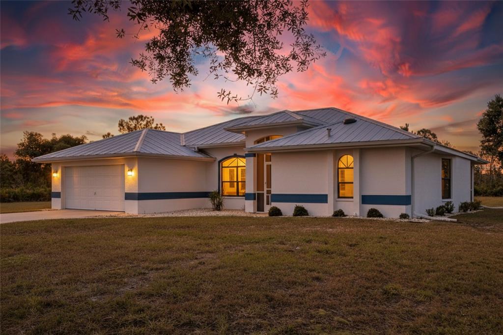 17200 River Ranch Court Punta Gorda, FL 33982 - Photo 38 of 39 a large house with a big yard and large trees