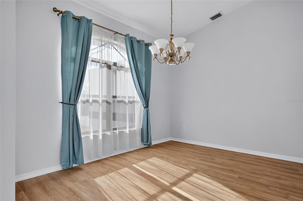 17200 River Ranch Court Punta Gorda, FL 33982 - Photo 7 of 39 a view of empty room with wooden floor and fan