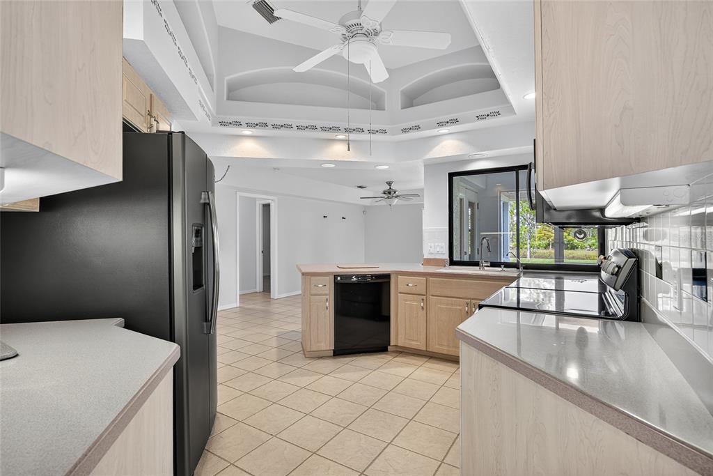 17200 River Ranch Court Punta Gorda, FL 33982 - Photo 8 of 39 a kitchen with stainless steel appliances kitchen island granite countertop a refrigerator and a stove top oven