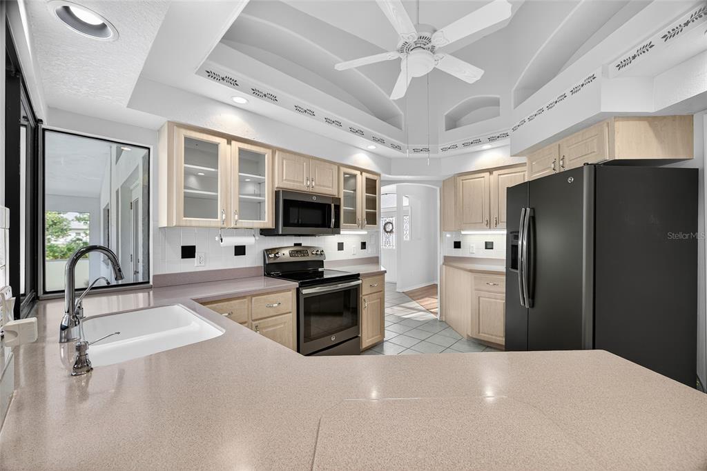 17200 River Ranch Court Punta Gorda, FL 33982 - Photo 10 of 39 a kitchen with stainless steel appliances a stove a refrigerator a sink dishwasher with a dining table and chairs