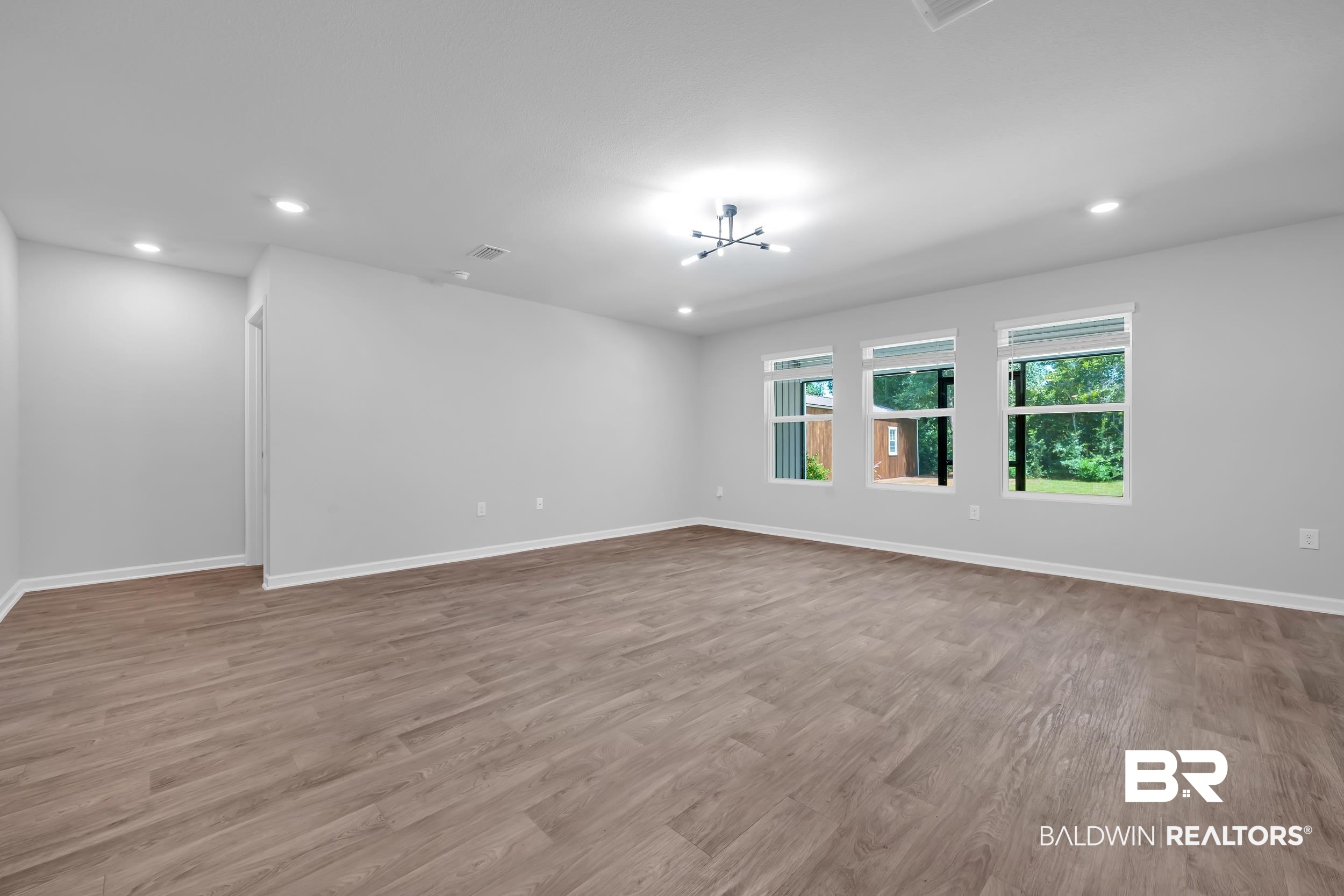 3070 Camino Real Loop Lillian, AL 36549 - Photo 7 of 46 Spacious interior room featuring light-toned walls and wood-finish flooring