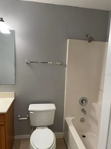 a bathroom with a sink a toilet and bathtub