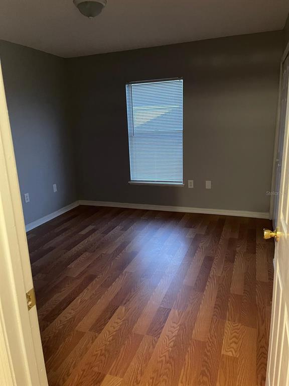 30404 Pongo Way Wesley Chapel, FL 33545 - Photo 5 of 15 an empty room with wooden floor and windows