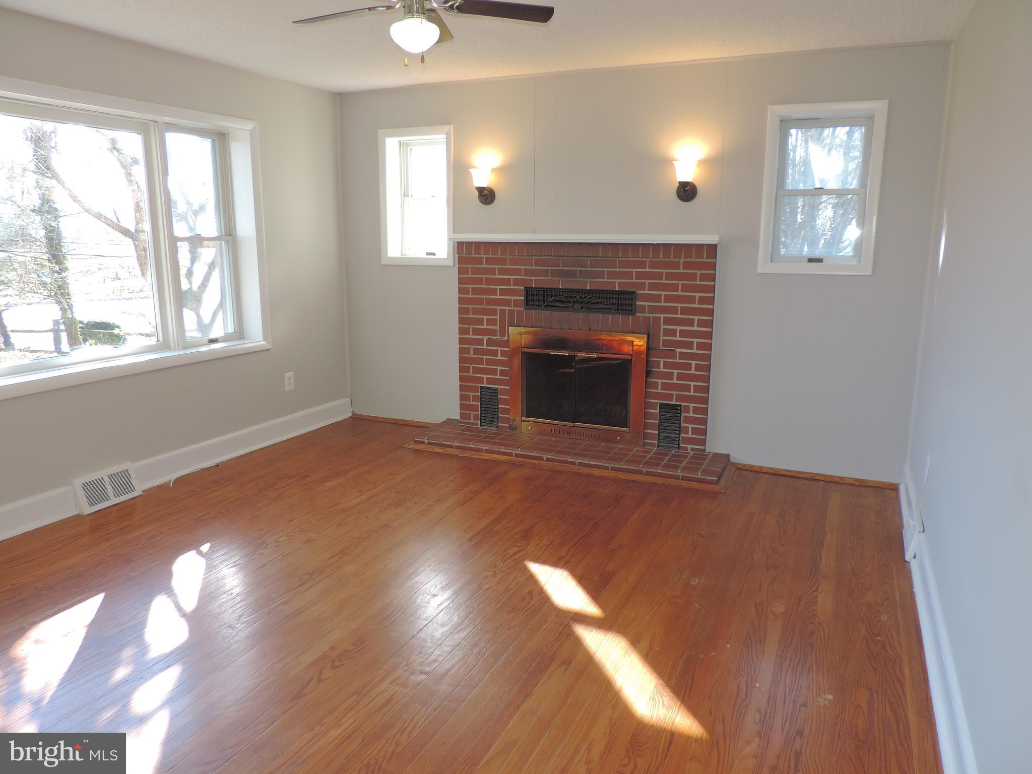 1414 Perryman Road Aberdeen, MD 21001 - Photo 2 of 28 Living room with fireplace and wood flooring