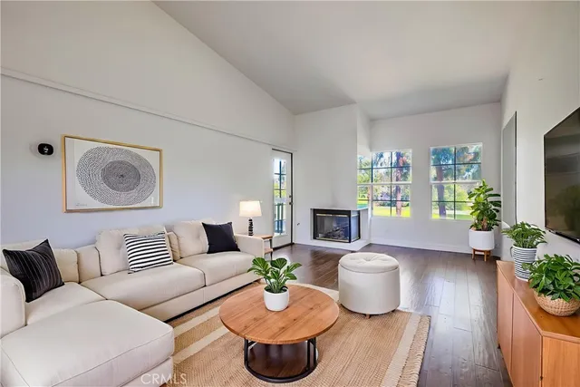 a living room with furniture and a floor to ceiling window