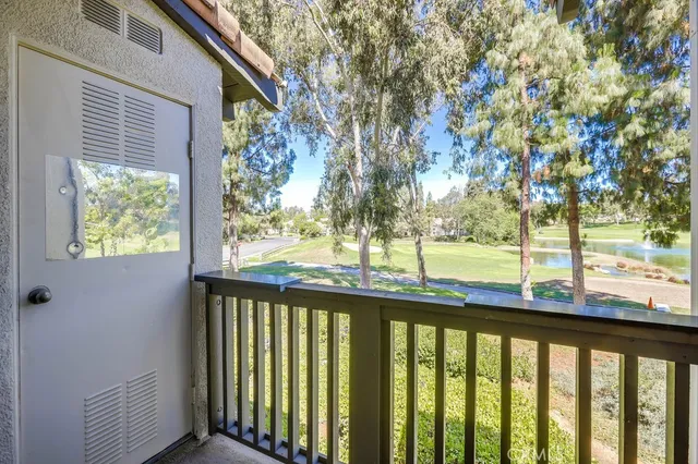 a view of large trees and yard from a balcony
