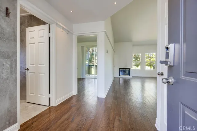 a view of a hallway with wooden floor windows and livingroom