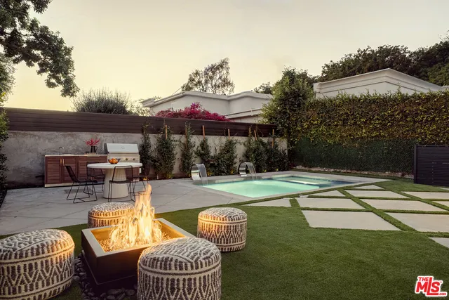 swimming pool view with a seating space