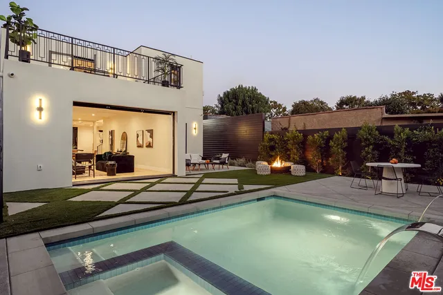 a view of a patio with swimming pool table and chairs