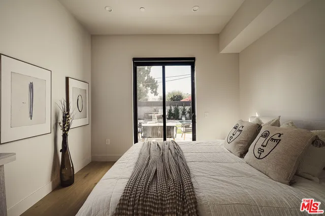 a bed sitting in a bedroom next to a window