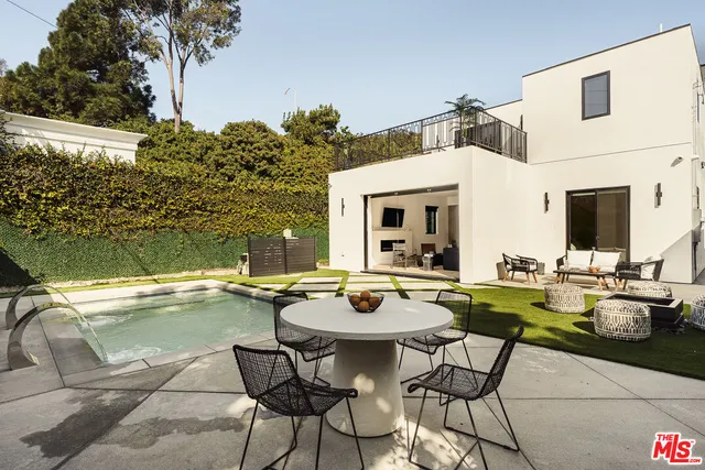 a view of a swimming pool with outdoor seating