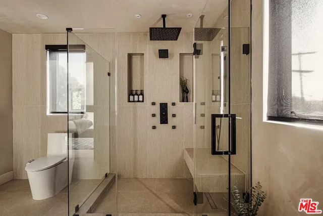 a bathroom with a toilet and a shower