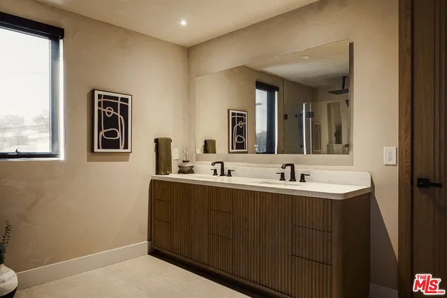 a bathroom with 2 sink and a mirror