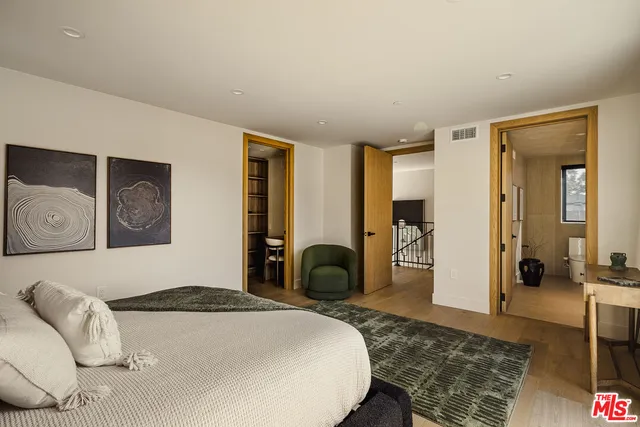 a bedroom with a bed and a couch