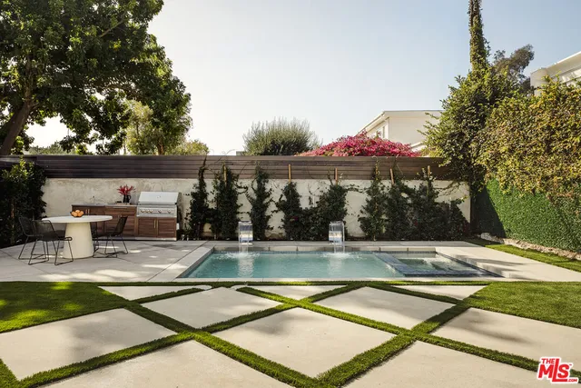 a view of swimming pool with a lounge chair