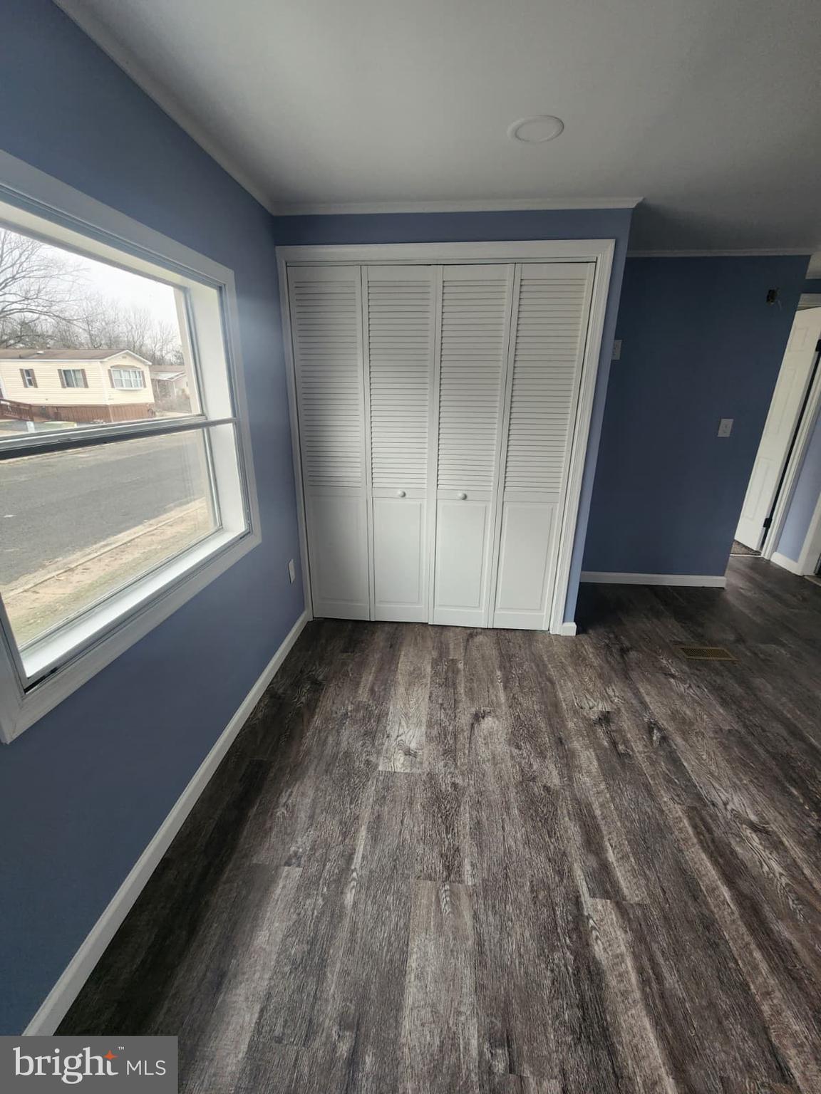 4191 Lake Road, Unit 48 Newfield, NJ 08344 - Photo 11 of 16 a view of empty room with wooden floor and fan