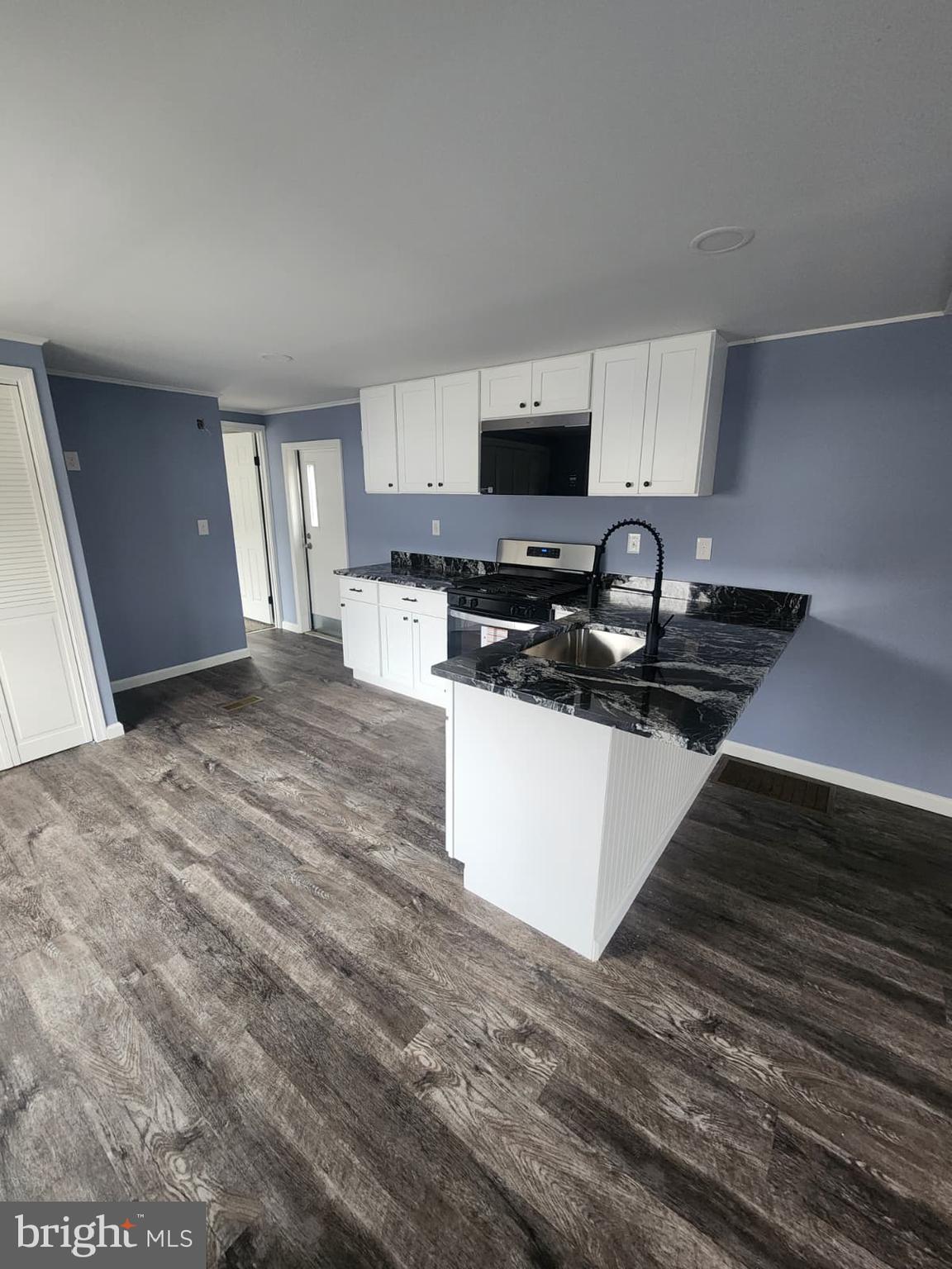 4191 Lake Road, Unit 48 Newfield, NJ 08344 - Photo 9 of 16 a kitchen with stainless steel appliances a sink a stove a microwave a sink a refrigerator and cabinets