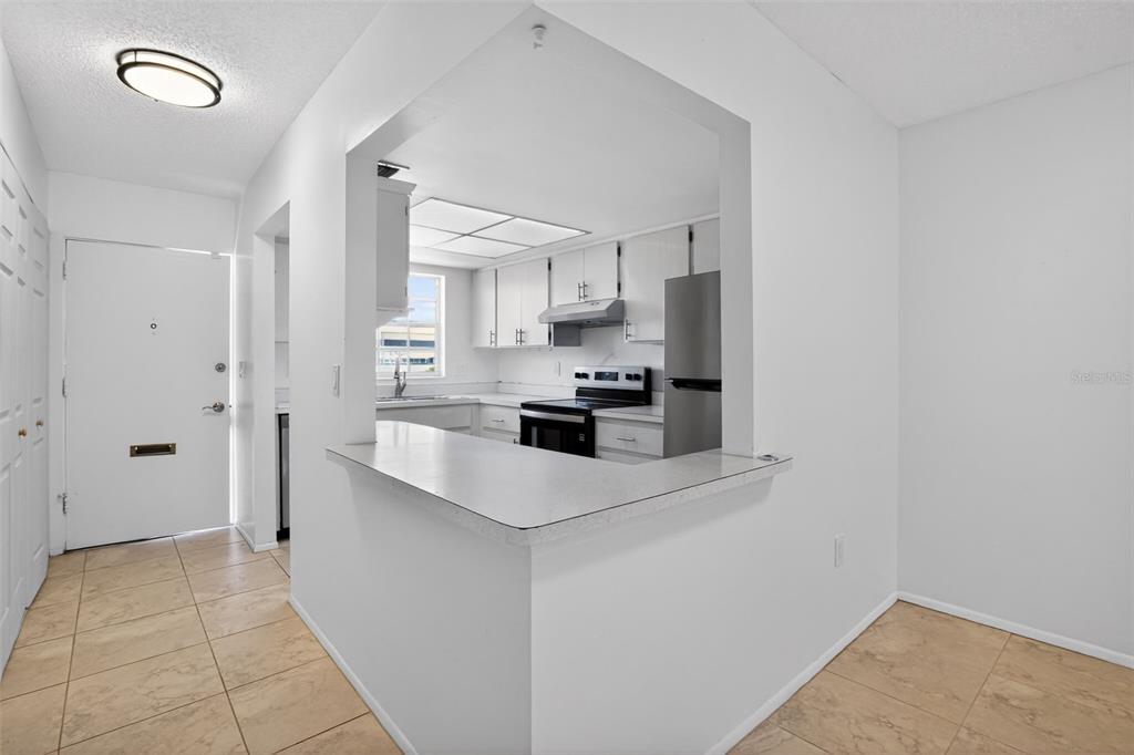 2560 Golf Course Drive, Unit 507 Sarasota, FL 34234 - Photo 16 of 43 a kitchen with stainless steel appliances a refrigerator and a stove