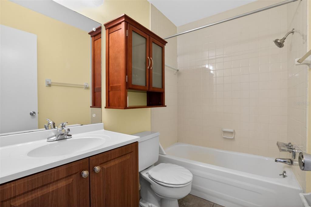 2560 Golf Course Drive, Unit 507 Sarasota, FL 34234 - Photo 26 of 43 a bathroom with a sink toilet a mirror and shower