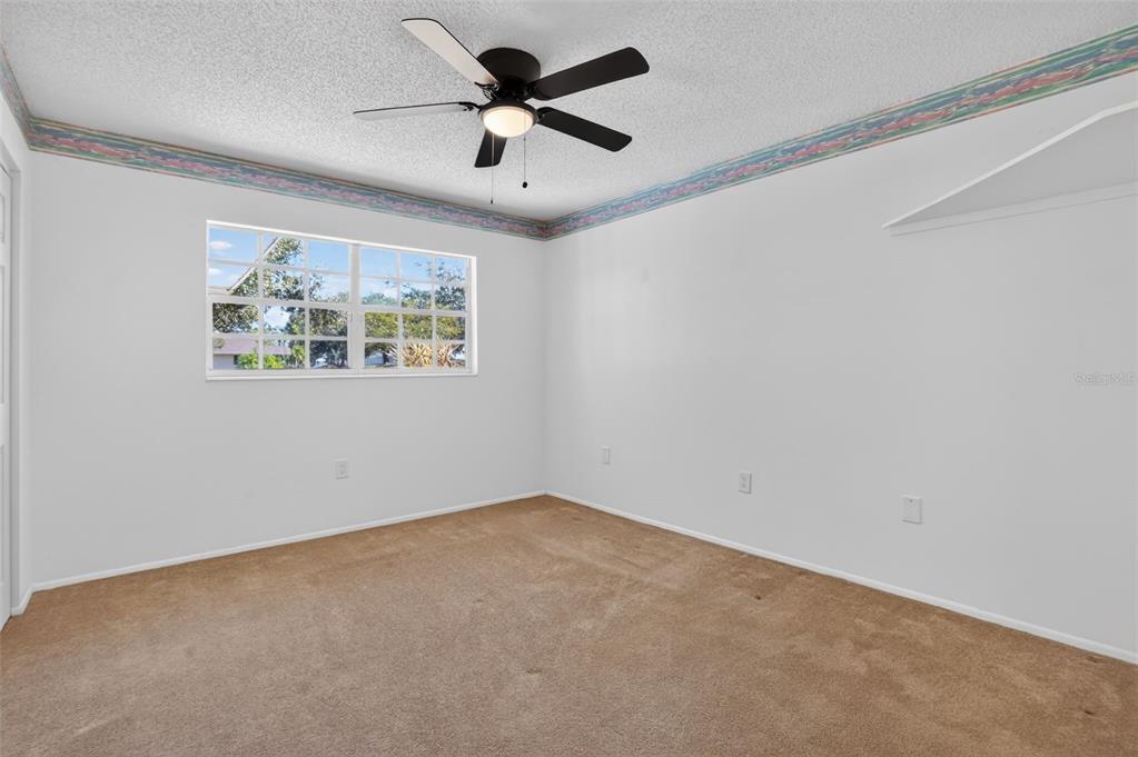 2560 Golf Course Drive, Unit 507 Sarasota, FL 34234 - Photo 28 of 43 an empty room with windows and a ceiling fan