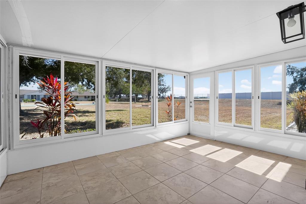 2560 Golf Course Drive, Unit 507 Sarasota, FL 34234 - Photo 30 of 43 a view of an empty room with a window and a fireplace