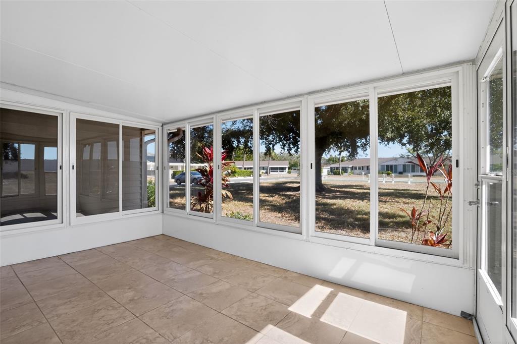 2560 Golf Course Drive, Unit 507 Sarasota, FL 34234 - Photo 32 of 43 a view of an empty room with wooden floor and a window