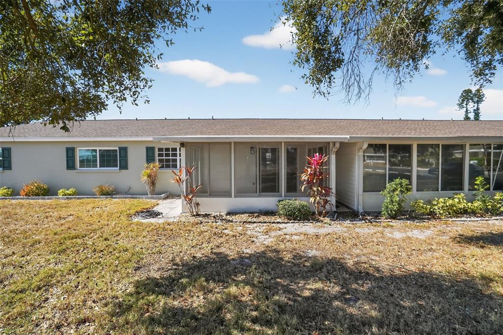 2560 Golf Course Drive, Unit 507 Sarasota, FL 34234 - Photo 41 of 43 a front view of house with yard outdoor seating and barbeque oven