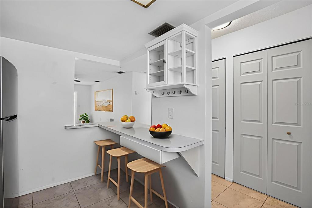 2560 Golf Course Drive, Unit 507 Sarasota, FL 34234 - Photo 6 of 43 a view of a workspace with furniture and wooden floor