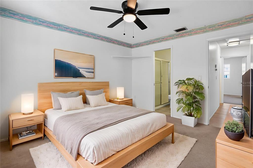 2560 Golf Course Drive, Unit 507 Sarasota, FL 34234 - Photo 8 of 43 a bedroom with bed and a chandelier