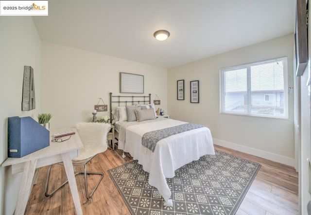 a bedroom with a bed and wooden floor