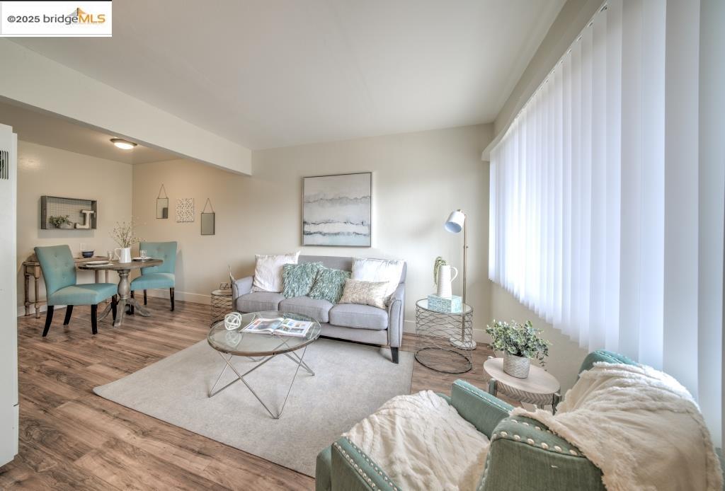 399 Schafer Road Hayward, CA 94544 - Photo 4 of 13 a living room with furniture and wooden floor