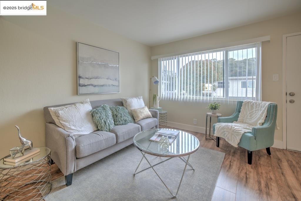 399 Schafer Road Hayward, CA 94544 - Photo 5 of 13 a living room with furniture and a large window