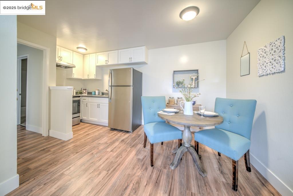 399 Schafer Road Hayward, CA 94544 - Photo 9 of 13 a view of a dining room with furniture and wooden floor