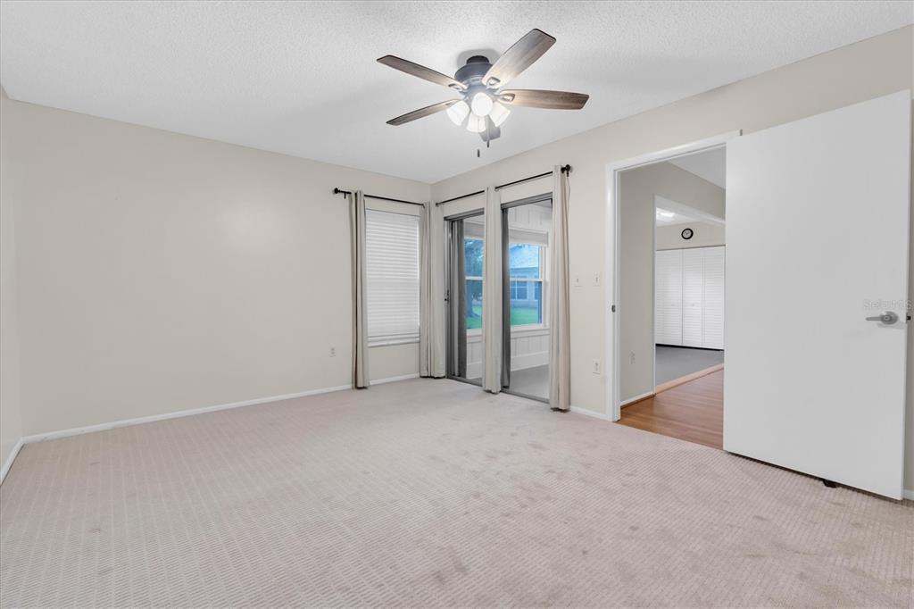 4814 Grist Mill Circle New Port Richey, FL 34655 - Photo 25 of 63 an empty room with a ceiling fan and a window