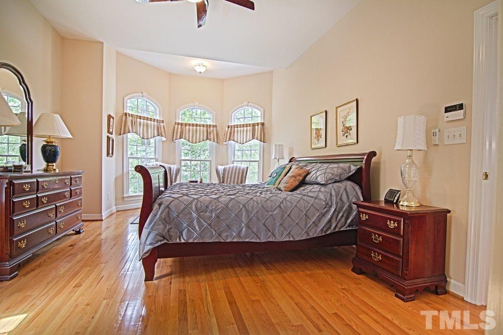 5305 Corbarron Court Raleigh, NC 27606 - Photo 13 of 21 Spacious first floor master bedroom featuring hardwood floors