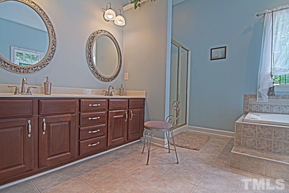 5305 Corbarron Court Raleigh, NC 27606 - Photo 14 of 21 Huge master bath with Jacuzzi tub overlooking pool and gorgeous landscaping